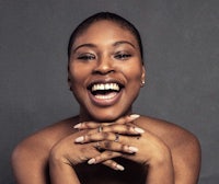 a black woman is smiling and posing for a photo
